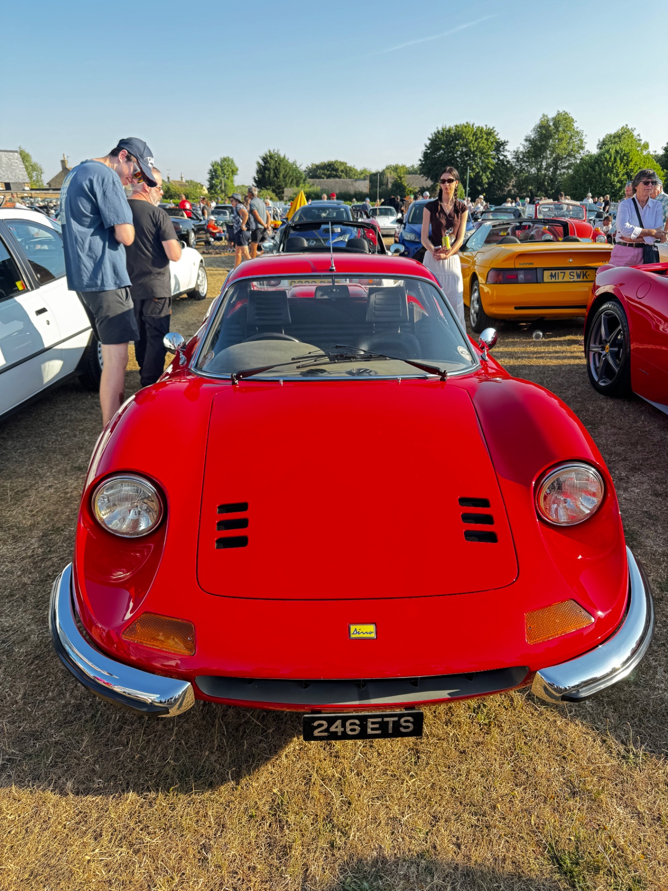 A red Ferrari Dino 246 GTS parked on the grass at the Greetham Car Show