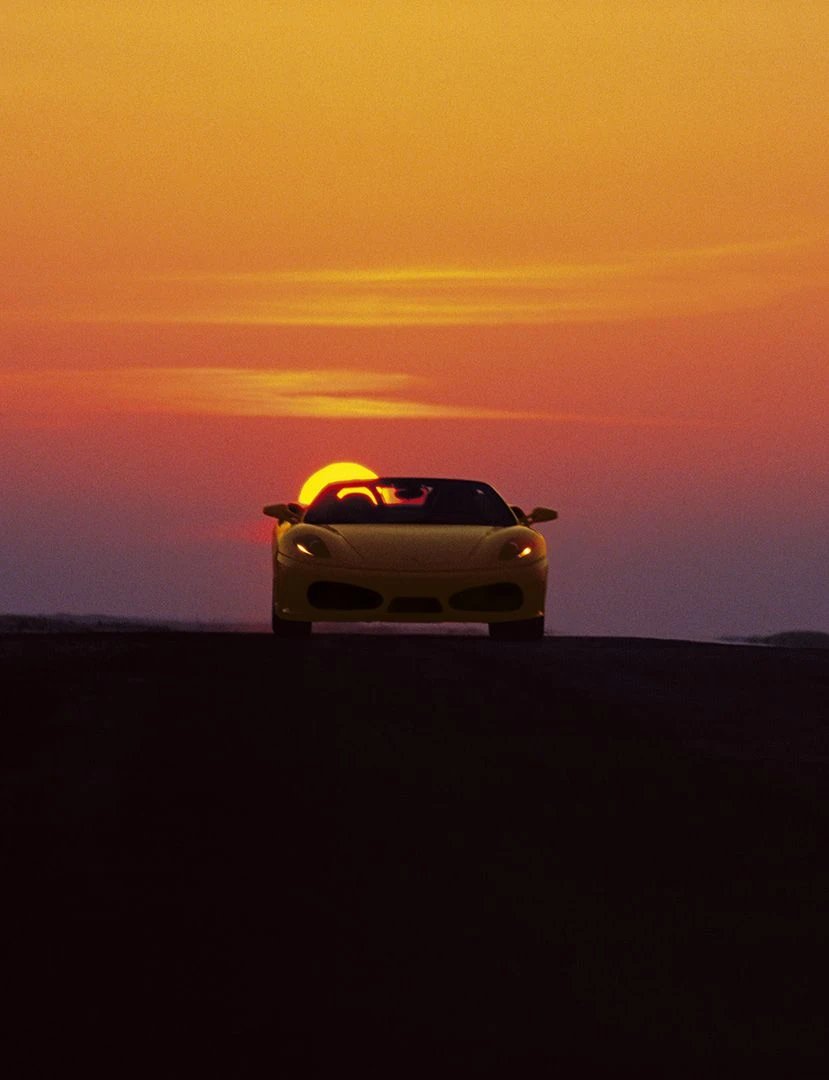 Ferrari F430 Spider on a desert road at sunset, official Ferrari launch photography