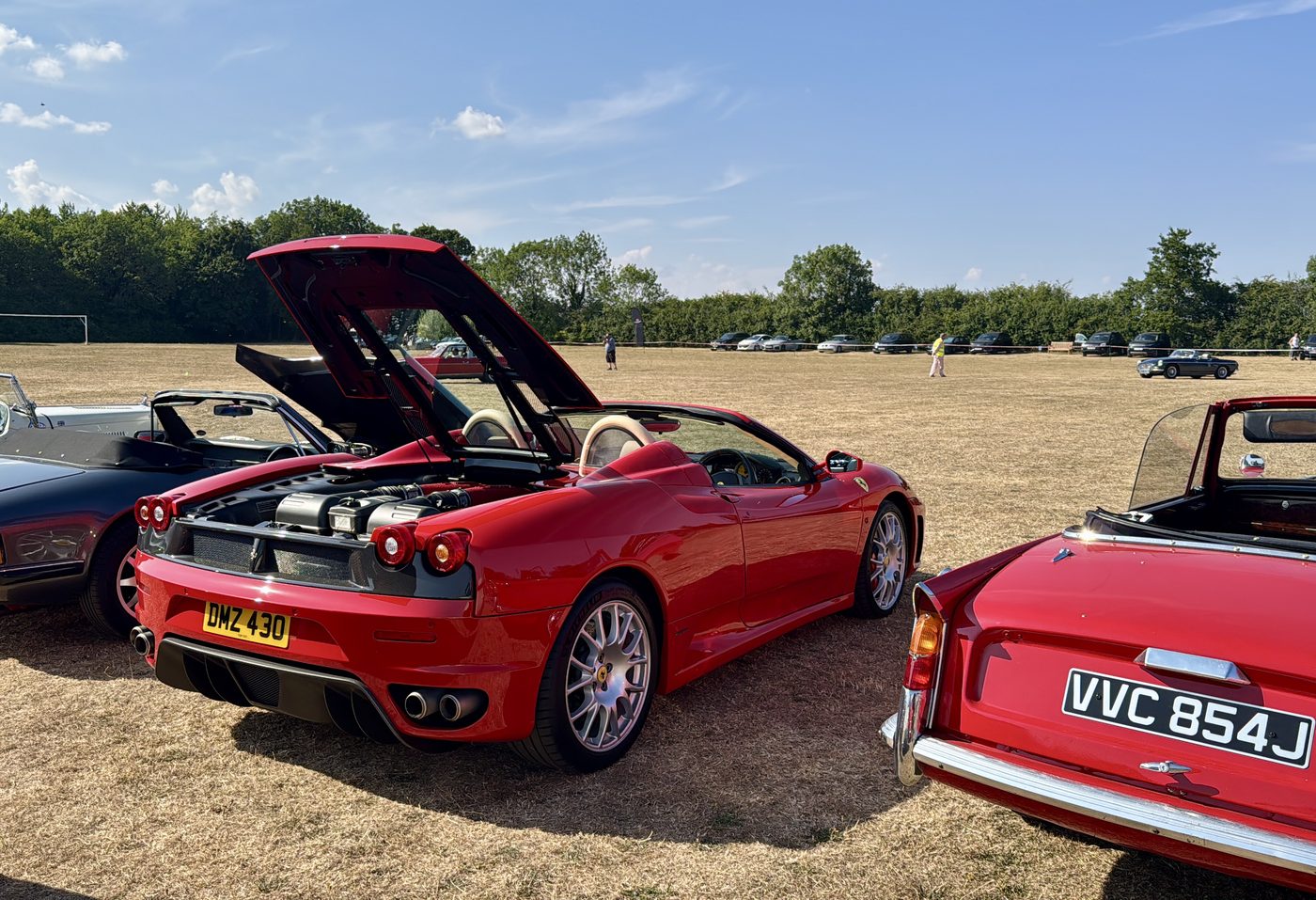 Red F430 Spider parked among classic cars at the Greetham Car Show