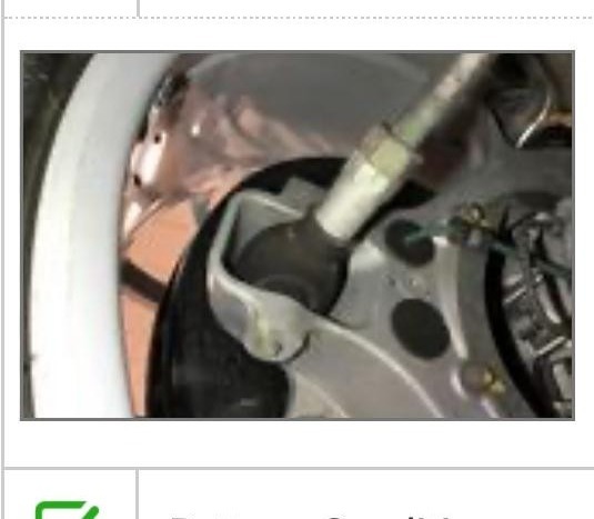 Close-up inspection photo of the front suspension component noted in the service report