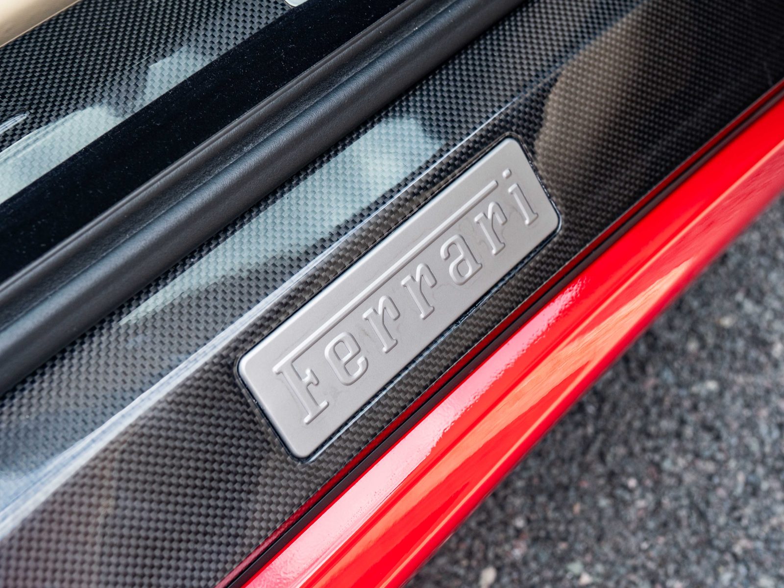 Carbon fibre sill kickplate with Ferrari script badge