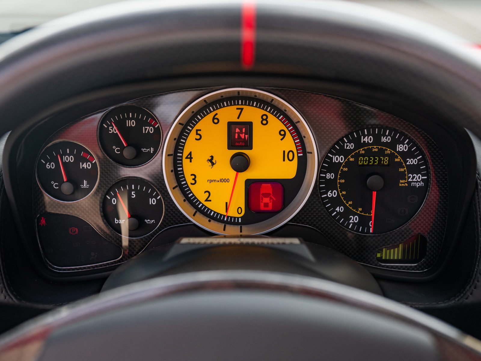 Giallo tachometer with red needle and Ferrari shield at the centre