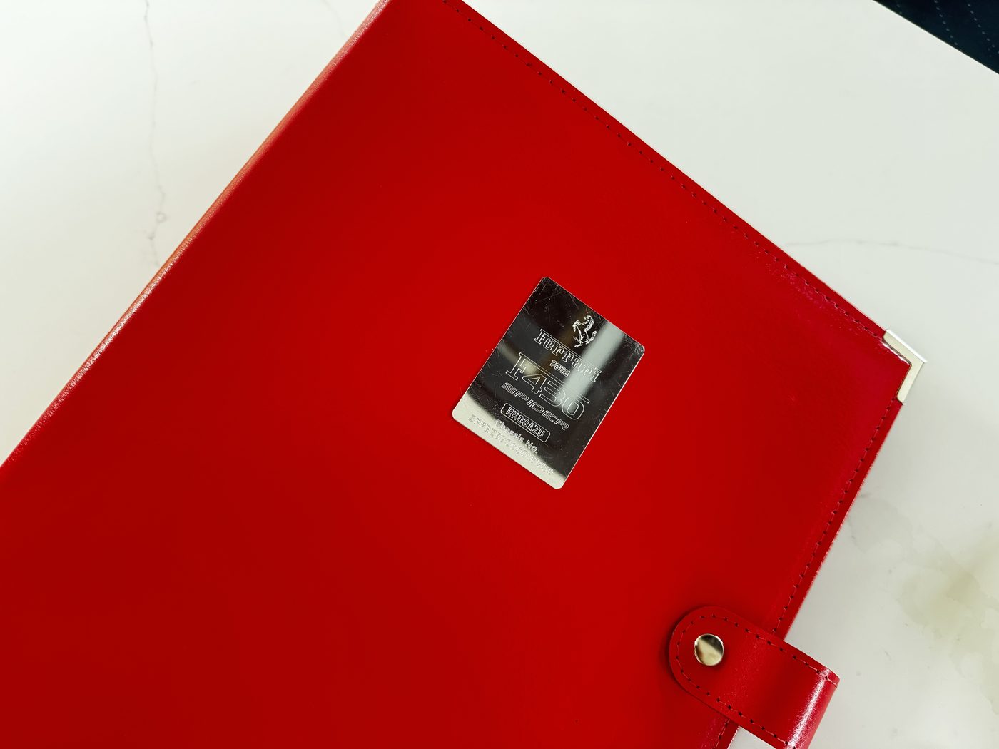 Original Ferrari owner's folder with engraved F430 Spider chassis plate